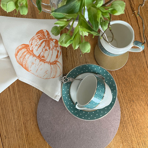 Tea set with tablemat and coaster designed by Jenny Duff, cup and saucer and a Turban squash design napkin by Lottie Day