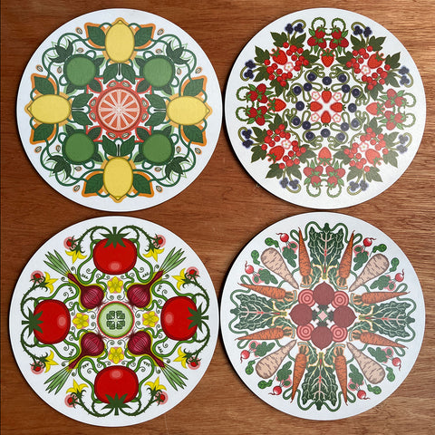 Four decorative placemats with geometic mandal designs berries vegetables salad citrus fruit designed by Rebecca Strickson