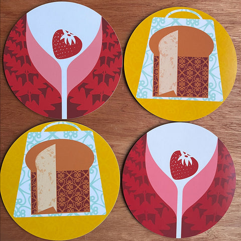 Four circular placemats designed by Gillian Blease with Panettone and Strawberry wine patterns